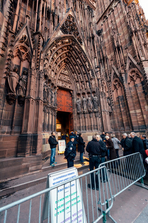 STRASBOURG, FRANCE - DEC 06, 2015: Armed security military forces at the entrance of the Notre-Dame de Strasbourg Cathedral checking every person before entrance - security measures after Paris Atacksのeditorial素材