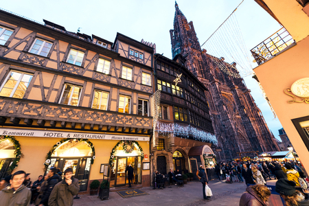 STRASBOURG, FRANCE - DEC 06, 2015: Place de la Cathedralee with impressiove view over hte Notre-Dame cathedrale of Strasbourg and Hotel and Restaurant Kammerzell House in central Strasbourg during Christmas Holidays Market Noelのeditorial素材