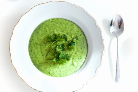 Tasty creamy spinach soup seasoned with fresh parsley made from organic ingredients view from aboveの写真素材