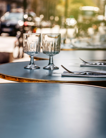 Eating in Paris - Breakfast lunch or dinner in a Parisian street restaurant cafe - round table is set in the most romatic city - Paris, Franceの写真素材