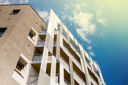 Modern energy efficient aluminum concrete facade and aluminum panels against blue clear skyの写真素材