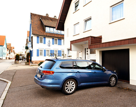 FREUDENSTADT, GERMANY - NOV 20, 2016: Modern Hybrid Volkswagen Passat wagon car parked on the German street with german architecture in the backgroundのeditorial素材