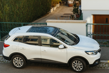 STRASBOURG, FRANCE - NOV 29, 2016: Aerial view of a white Renault Kadjar SUV car parked near a beautiful house. Renault is the bigest French automobile makerのeditorial素材