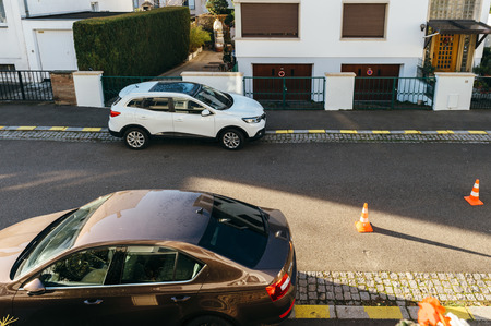 PARIS, FRANCE - NOV 29, 2016: Renault Kadjar and Skoda Ocatavia cars parked in front of a house early in the morning with safety cones during construction worksのeditorial素材
