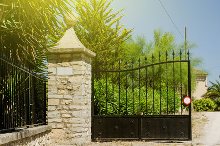 Entrance gate to a spanish hacienda on a bright sunny day with sun flareの写真素材