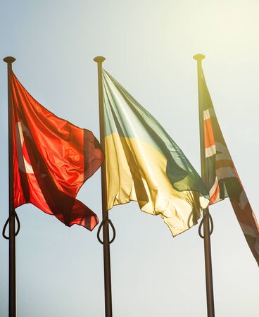 Three flags - Ukraine flag in front of Council of Europe building. The flag is poistionedd between Turkey and United Kingdom flags on a sunny dayの写真素材