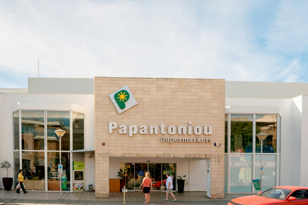 PAPHOS, CYPRUS - OCT 28, 2014: Papatoniu supermarket chain in Cyprus on a sunny day with people entering to buy food and non-food products. Papatoniu is the leading supermarket in Cyprusのeditorial素材