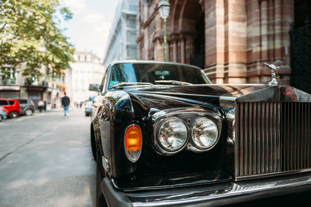 PARIS, FRANCE - SEP 12, 2016: Headlight and logotype of a exclusive Luxury Rolls-Royce car limousine parked in city during fashion wedding vip event waiting for passenger. Rolls-Royce Limited is a British car-manufacturing and, later, aero-engine manufactのeditorial素材