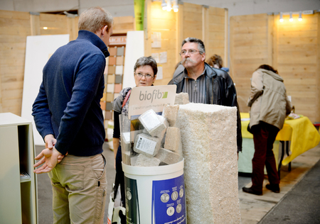 PARIS, FRANCE - OCT 30, 2015: sales person engineer explaining to couple the advantages of using ecological foam for the new house during construction stageのeditorial素材