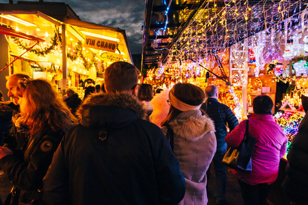 STRASBOURG, FRANCE - 9 DEC 2016: Couple visiting the oldest Christmas Market worldwide in central Strasbourg, Alsace with multiple market stalls selling traditional food and wineのeditorial素材