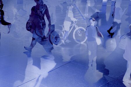 Abstract modern city with commuters people walking over reflections. Composite image.の写真素材