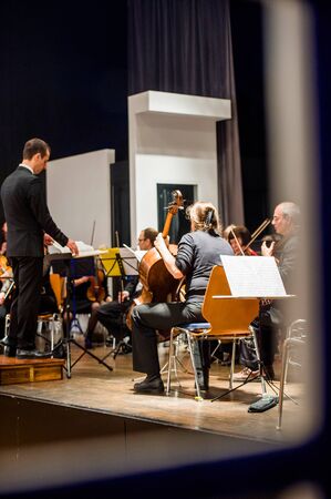 STRASBOURG, FRANCE - MAR 18, 2016: View through the window of a building - conductor perparing classical music orchestra for the concert in Strasbourg, Franceのeditorial素材
