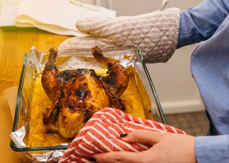 Delicious roast chicken directly from oven made under special Swedish recipe with ginger, oranges, apples and other organic food ingredients - ready to be servedの写真素材