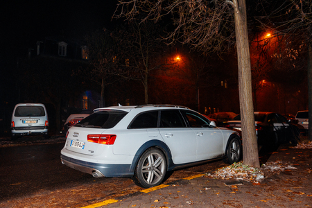 STRASBOURG, FRANCE - DEC 6, 2017: Rear vew of a white Audi A6 Allroad car parked at night in the cityのeditorial素材