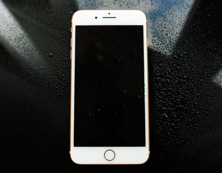 PARIS, FRANCE - SEP 26, 2016: New Apple iPhone 7 Plus under rain waterdrops. New iPhone7 is one of...