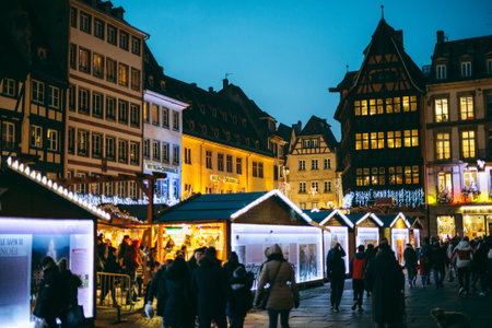 STRASBOURG, FRANCE - DEC 20, 2016: Famous Christmas Market with Place de la Cathedrale with tourists and locals in front of Notre-Dame Cathedral and iconic maison Kammerzell at duskのeditorial素材