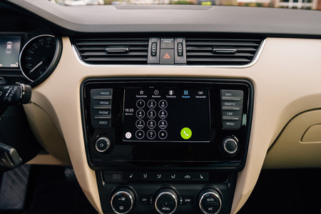 PARIS, FRANCE - DEC 13, 2016: Apple CarPlay phone main screen in modern car dashboard. CarPlay is an Apple standard that enables a car radio or head unit to be a display and controller for an iPhone. It is available on all iPhone 5 and later with at leastのeditorial素材