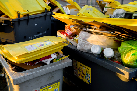 STRASBOURG, FRANCE - DEC 19, 2016: Close-up detail of dumpsters being full with garbage before winter holidaysのeditorial素材