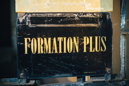 STRASBOURG, FRANCE - DEC 1, 2016: Formation Plus translating as More Training - inscription with golden letters at the entrance of the buldingのeditorial素材