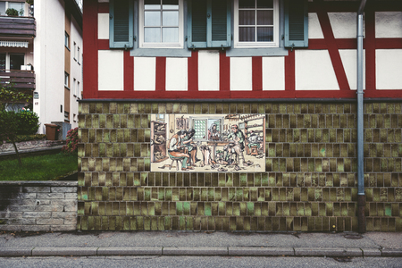BADEN-BADEN, GERMANY -  NOV 20, 2014: Vintage cobbler shoemaker manufacture process sign on hte facade of an old building in Baden-Baden, Germanyのeditorial素材