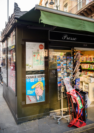 PARIS, FRANCE - JAN 21, 2017: French press newsstand featuring headlines with Donald Trump inauguration as the 45th President of the United States in Washington, D.C as a comic satire on Charlie Hebdo coverのeditorial素材