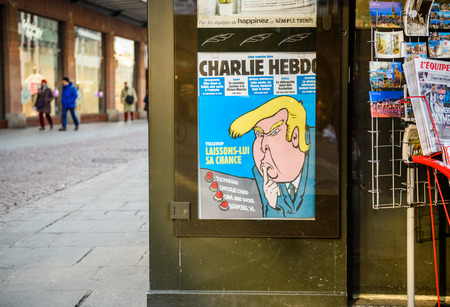 PARIS, FRANCE - JAN 21, 2017: French press newsstand featuring headlines with Donald Trump inauguration as the 45th President of the United States in Washington, D.C as a comic satire on Charlie Hebdo coverのeditorial素材