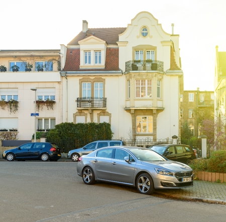STRASBOURG, FRANCE - DEC 25, 2016: typical french street with peugeot car parked in frontof the timbered house in strasbourg, franceのeditorial素材