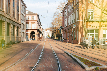MULHOUSE, FRANCE - DEC 12, 2015: Central Mulhouse neighborhood with tramway lanes and pedestrians walking on a morning Saturdayのeditorial素材