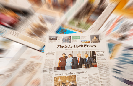 PARIS, FRANCE - JAN 21, 2017: The New York Times above major international newspaper journalism featuring headlines with Donald Trump, Barack Obama, Melania Trump and Michele Obama inauguration as the 45th President of the United States in Washington, D.Cのeditorial素材