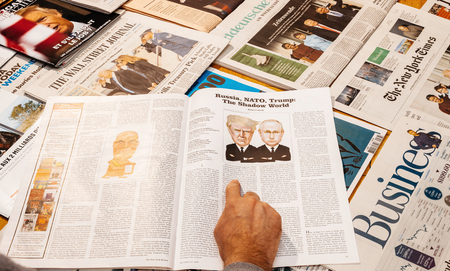 PARIS, FRANCE - JAN 21, 2017: The New York Review magazine above major international newspaper journalism featuring news about protests during inauguration as the 45th President of the United States in Washington, D.C and relatiosn with Vladimir Putinのeditorial素材