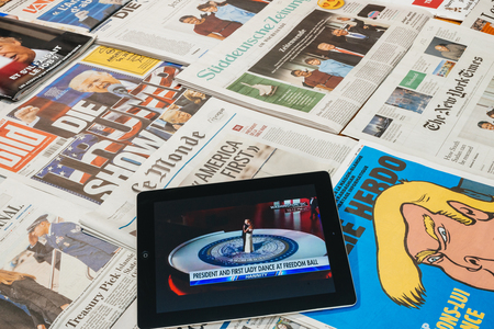 PARIS, FRANCE - JAN 21, 2017: iPad tablet with Donald and Melania first dance on iPad above major international newspaper journalism featuring headlines with Donald Trump inauguration as the 45th President of the United States in Washington, D.Cのeditorial素材