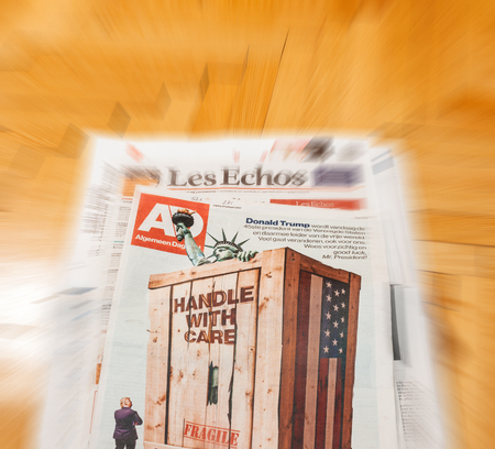 PARIS, FRANCE - JAN 21, 2017: Algemeen Dagblad Dutch magazine above major international newspaper journalism featuring portrait of Donald Trump inauguration as the 45th President of the United States in Washington, D.Cのeditorial素材