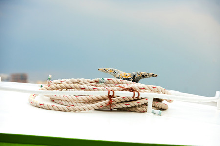 Detail of rope on a passenger taxi boat in the port of Athens, Greece with water in the background の写真素材