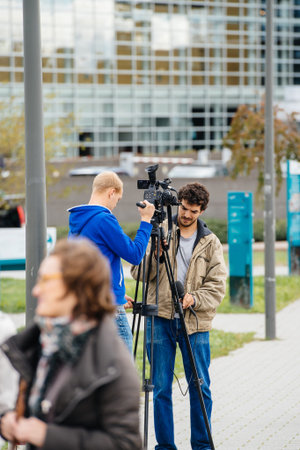 STRASBOURG, FRANCE - OCT 7, 2016: Rear view of journalist and cameraman reporter working...