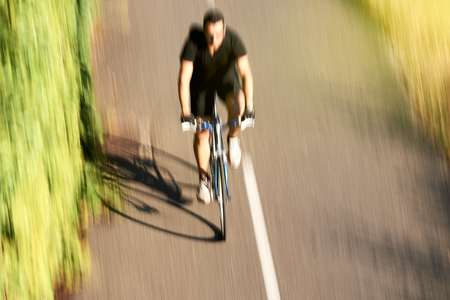 Silhouette of sportive view from above of adult cyclist sport man workout near the European Parliament building in Strasbourg on a calm summer day near Ill riverの写真素材