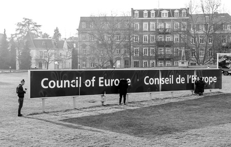 STRASBOURG, FRANCE - FEB 2, 2017: Workers taking care of the Council of Europe Conceil de Europe blue signage in front of the international organisation focused on promoting human rights, democracy and the rule of law in Europeのeditorial素材