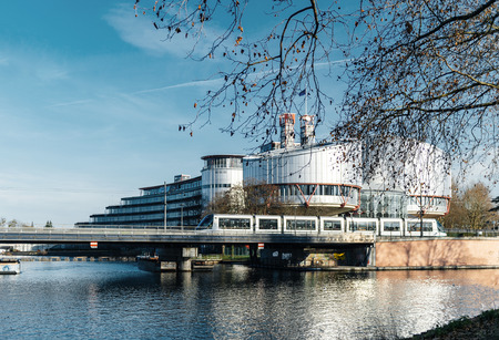 STRASBOURG, FRANCE - DEC 25, 2015: Large building of the European Court of Human Rights building in Strasbourg, France on a warm winter day and Ill river. ECHR is a international court established by the European Convention on Human Rights.のeditorial素材