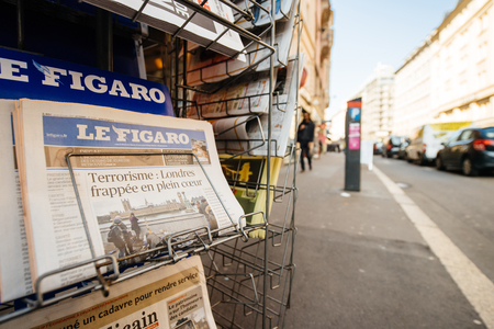 PARIS, FRANCE - MAR 23, 2017: Le Figaro French magazine newspaper from press kiosk newsstand featuring headlines following the terrorist incident in London at the Westminster Bridgeのeditorial素材