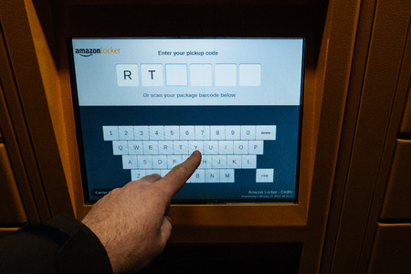 PARIS, FRANCE - FEB 15, 2017:Point of view of customer looking at the Amazon Locker digital touchscreen - Amazon Locker is a self-service parcel delivery service offered by online retailer Amazon.com. Amazon customers can select any Locker location as theのeditorial素材
