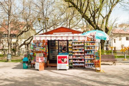 BUCHAREST, ROMANIA - APR 1, 2016: Woman selling sweets, biscuits and soda water in boutique located in Parcul Pita Romana in central Bucharestのeditorial素材