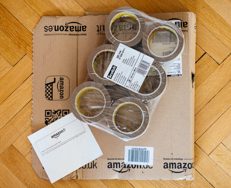 PARIS, FRANCE - MAR 23, 2017: Amazon cardboard box unpacked and 3m Scotch tape package - directly above viewのeditorial素材