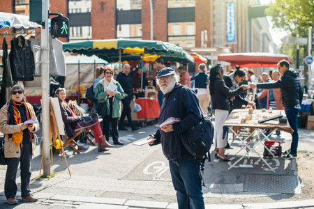 STRASBOURG, FRANCE - APR 8, 2017: Political agitation at French market for the upcoming French presidential election 2017 - senior French man distribution political information at marketのeditorial素材