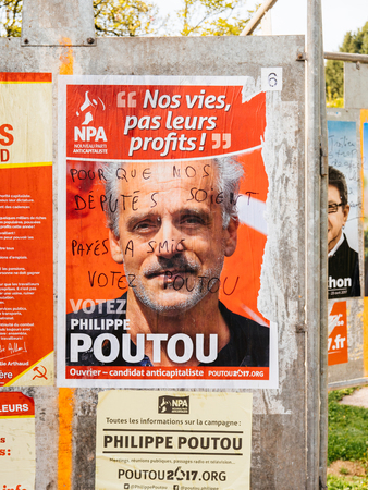STRASBOURG, FRANCE - APR 12, 2017: Official campaign posters of Philippe Poutou, political party leader of Nouveau Parti anticapitaliste (NPA), ones of the eleven candidates running in the 2017 French presidential electionのeditorial素材