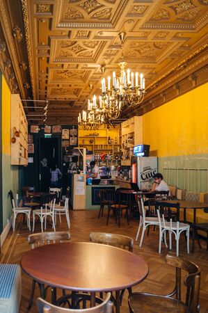 BUCHAREST, ROMANIA - APR 1, 2016: Interior of a traditional romanina bar with a single male customer drinking a Ciuc beer in central Old Bucharest Bucurestiのeditorial素材