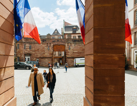 STRASBOURG, FRANCE - APR 23, 2017: Front view of people walking toward Voting station Bureau de Vote decorated with French Flags for  the 2017 French presidential elections postedのeditorial素材