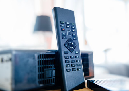 Small remote control next to wireless tv box used for TV Internet Telephone communication via fiber...