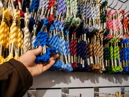 STRASBOURG, FRANCE - APR 27, 2017: Interior of Textile Tissue Fabric shop with multicolored and diverse accessories for sewing tools and accessories - multicolored thread for macrameのeditorial素材