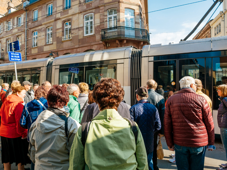 STRASBOURG, FRANCE - APR 27, 2017: Group of senios tourists waiting for hte tramway to pass to discover the French city of Strasbourg, Alsaceのeditorial素材