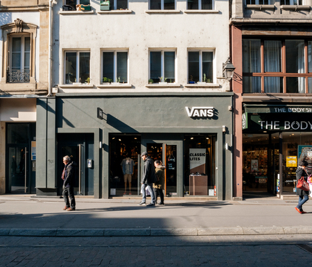STRASBOURG, FRANCE - APR 27, 2017: Pedestrians walking in front of the Vans in France - Vans is an American manufacturer of shoes, based in Cypress, California, owned by VF Corporationのeditorial素材