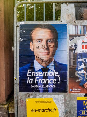 PARIS, FRANCE - MAY 9, 2017: Emmanuel Macron portrait poster detail next to polling place after the second round of the French presidential election with the marker inscription Member of Bilderberg groupのeditorial素材
